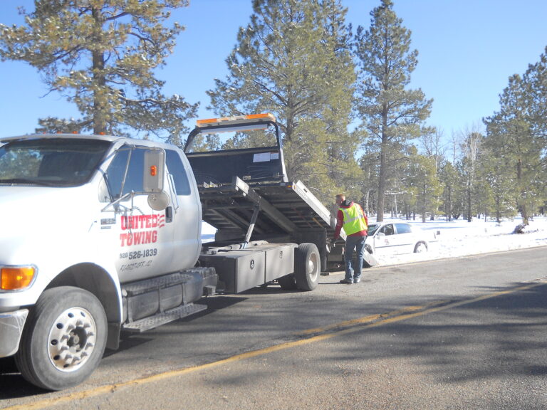 United Towing flatbed hauling a car on I-40 near Flagstaff